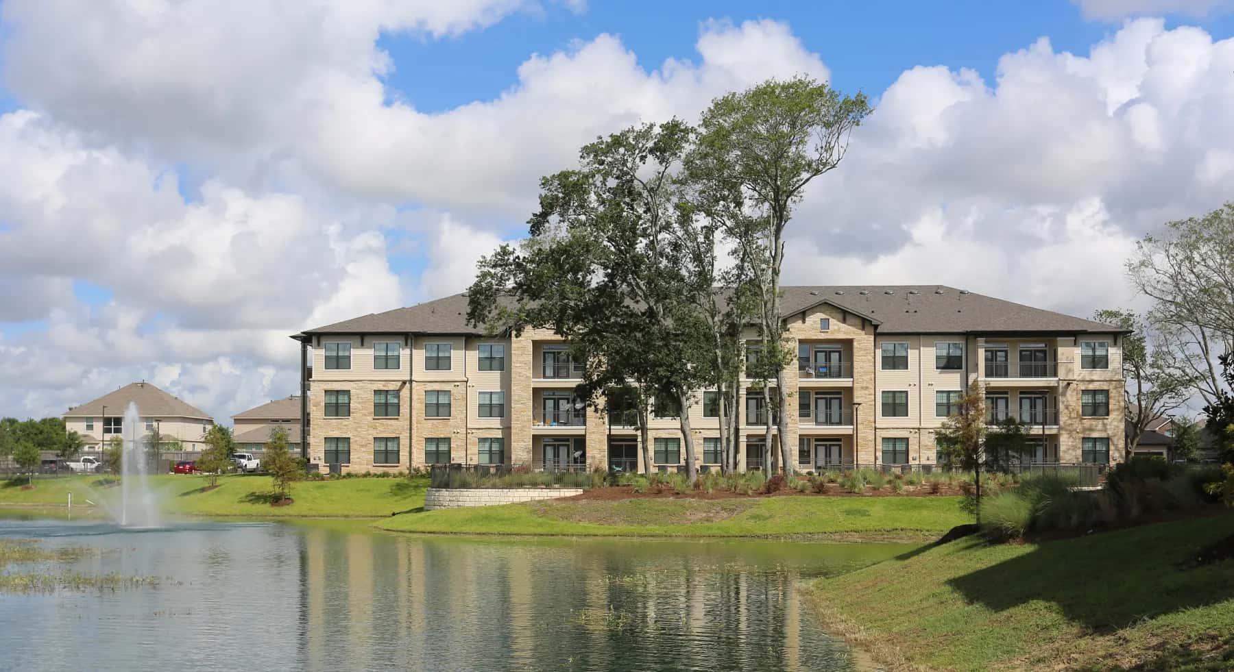 West End Fayetteville, a three-story garden-style apartment community beside a pond